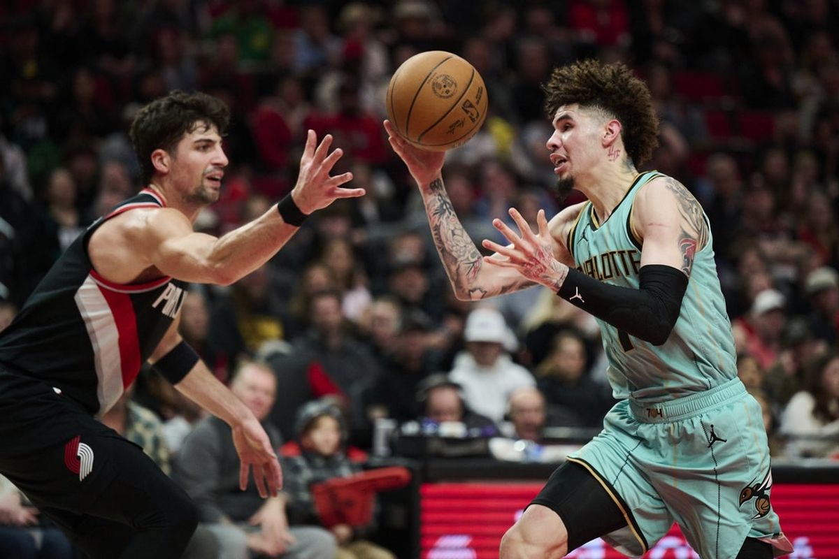 Feb 22, 2025; Portland, Oregon, USA; Charlotte Hornets guard LaMelo Ball (1) loses control of the basketball during the first half against Portland Trail Blazers forward Deni Avdija (8) at Moda Center. Mandatory Credit: Troy Wayrynen-Imagn Images