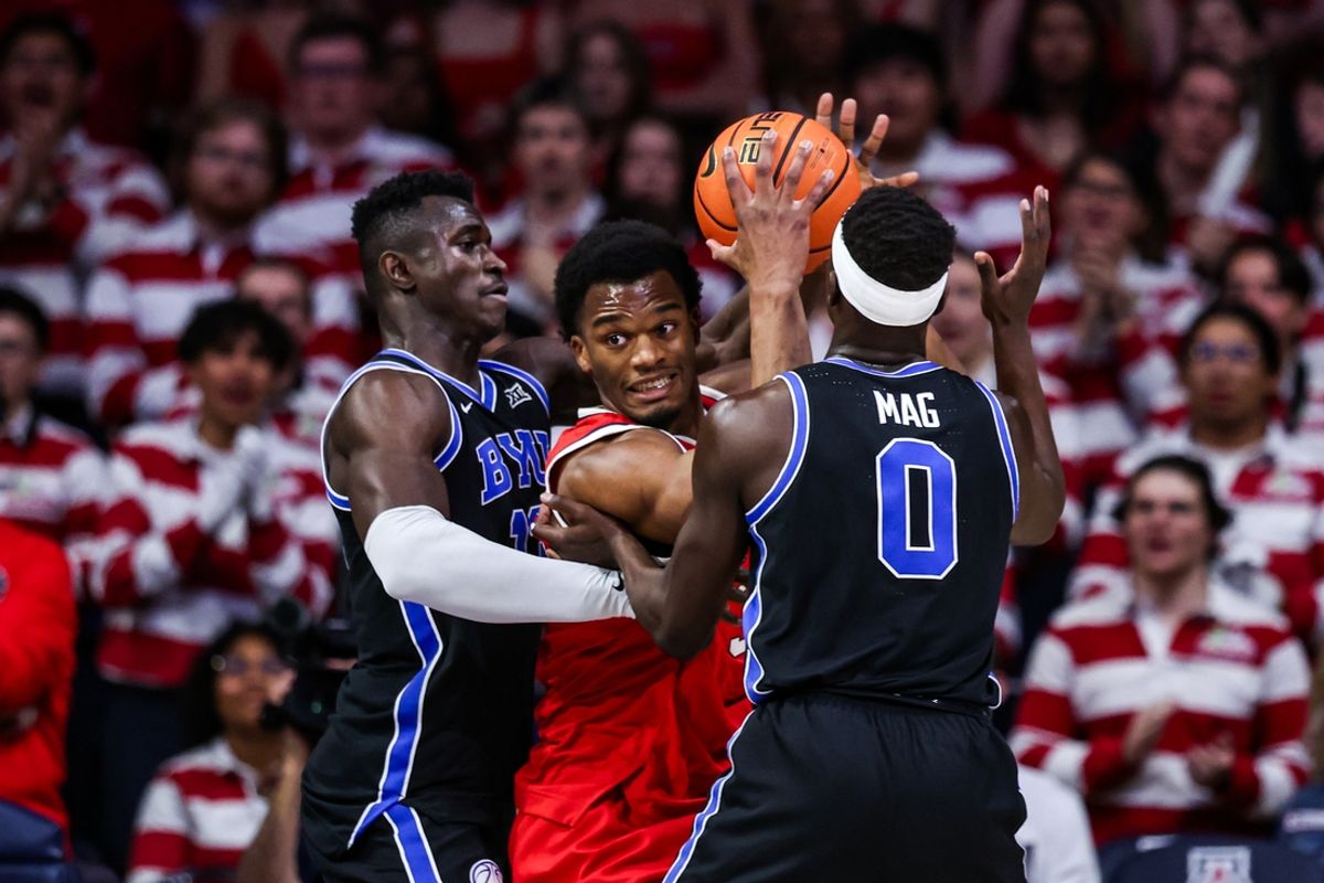 Feb 22, 2025; Tucson, Arizona, USA; Arizona Wildcats forward Tobe Awaka (30) looks to pass the ball while BYU Cougars center Keba Keita (13) and forward Mawot Mag (0) both attempt to block him during the first half at McKale Center. Mandatory Credit: Aryanna Frank-Imagn Images