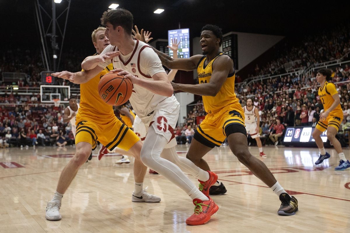 Feb 22, 2025; Stanford, California, USA; Stanford Cardinal forward Maxime Raynaud (42) is double-teamed by California Golden Bears forwards Rytis Petraitis (left) and Lee Dort (34) during the first half at Maples Pavilion. Mandatory Credit: D. Ross Cameron-Imagn Images