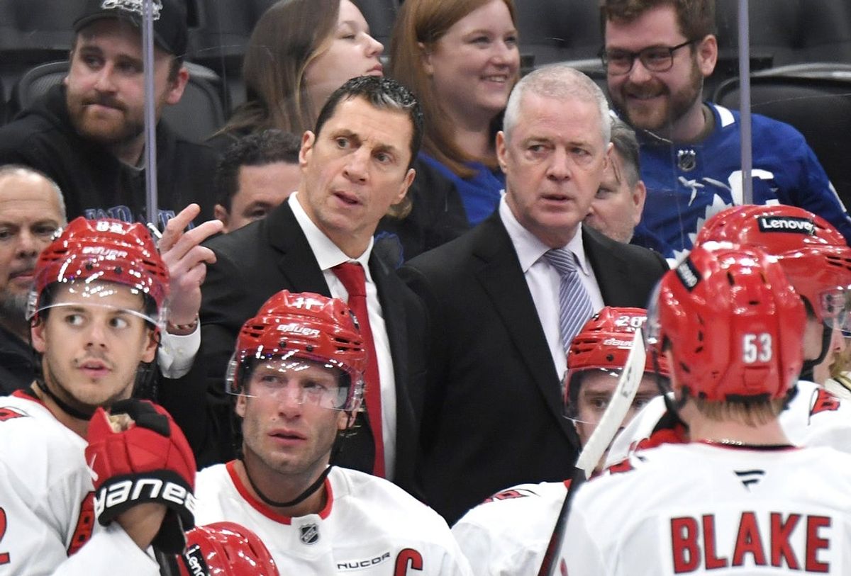 Feb 22, 2025; Toronto, Ontario, CAN;  Carolina Hurricanes head coach Rod Brind'Amour gestures as he speaks to his players and assistant coach Jeff Daniels in the third period against the Toronto Maple Leafs at Scotiabank Arena. Mandatory Credit: Dan Hamilton-Imagn Images