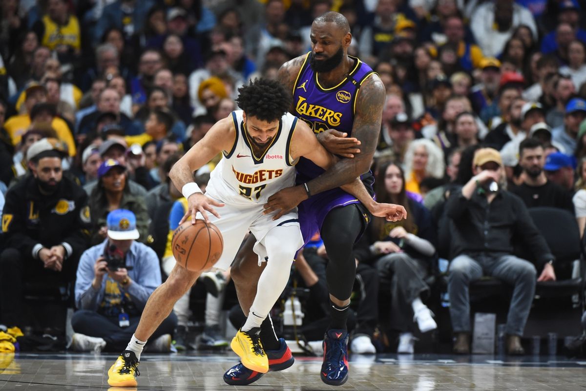 Feb 22, 2025; Denver, Colorado, USA; Denver Nuggets guard Jamal Murray (27) handles the ball as he is defended by Los Angeles Lakers forward LeBron James (23) during the second half at Ball Arena. Mandatory Credit: Christopher Hanewinckel-Imagn Images