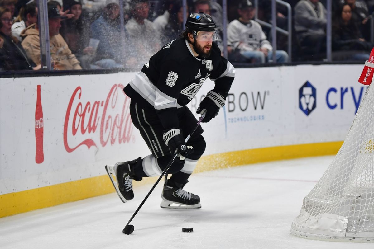 Feb 22, 2025; Los Angeles, California, USA; Los Angeles Kings defenseman Drew Doughty (8) controls the puck against the Utah Hockey Club during the third period  at Crypto.com Arena. Mandatory Credit: Gary A. Vasquez-Imagn Images