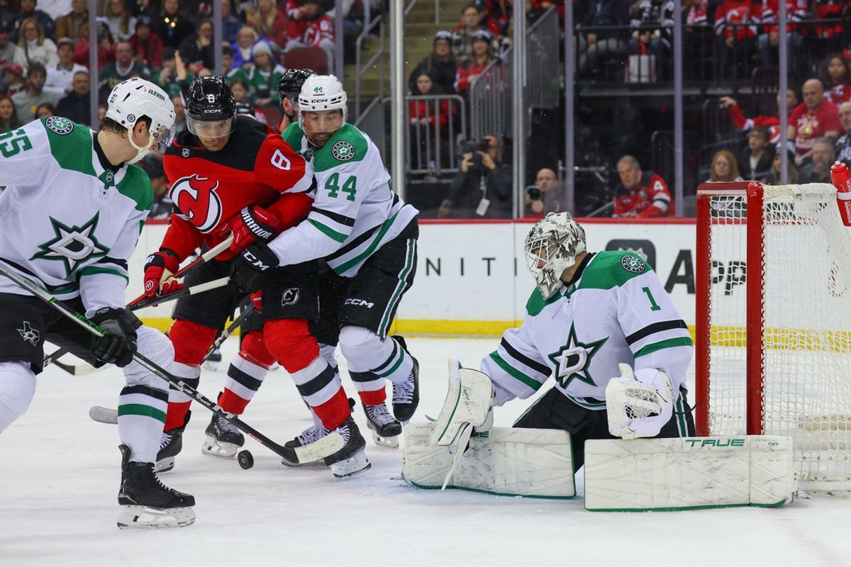Feb 22, 2025; Newark, New Jersey, USA; New Jersey Devils defenseman Johnathan Kovacevic (8) and Dallas Stars defenseman Cody Ceci (44) battle for the puck after a save by Dallas Stars goaltender Casey DeSmith (1) during the second period at Prudential Center. Mandatory Credit: Ed Mulholland-Imagn Images