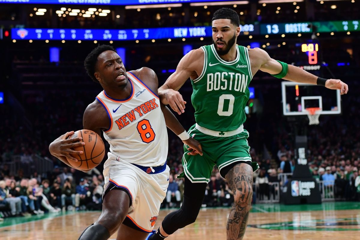 Feb 23, 2025; Boston, Massachusetts, USA;  New York Knicks forward OG Anunoby (8) drives to the basket while Boston Celtics forward Jayson Tatum (0) defends during the first half at TD Garden. Mandatory Credit: Bob DeChiara-Imagn Images