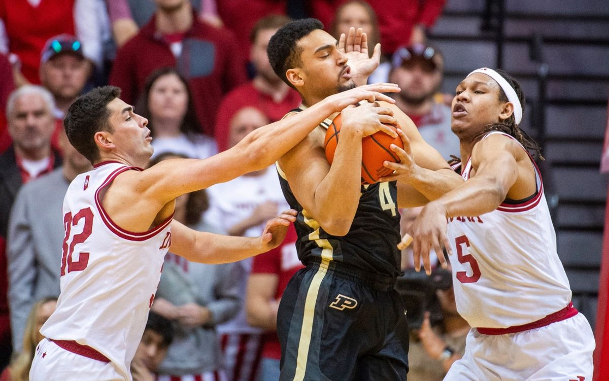 Purdue's Trey Kaufman-Renn (4) is tied up by Indiana's Malik Reneau (5) and Trey Galloway (32) during the Indiana versus Purdue mens basketball game at Simon Skjodt Assembly Hall on Sunday, Feb. 23, 2025.