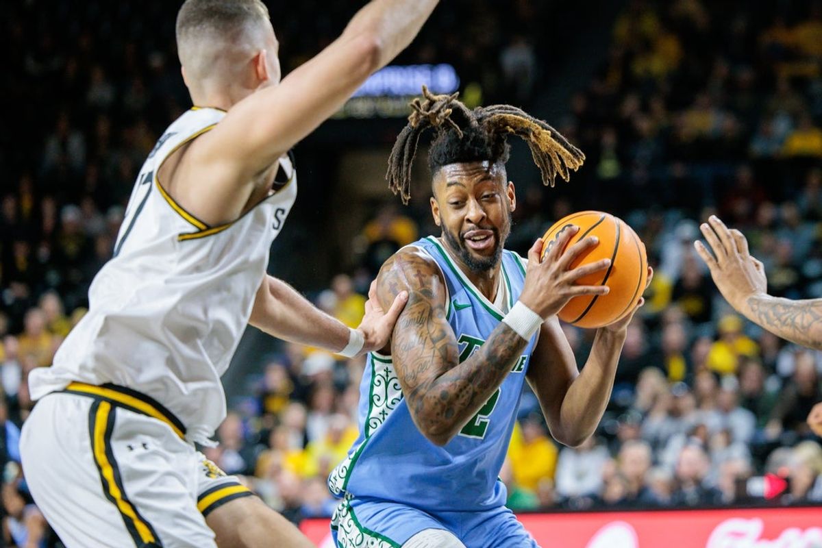Feb 23, 2025; Wichita, Kansas, USA; Tulane Green Wave forward Gregg Glenn III (2) drives to the basket during the first half against the Wichita State Shockers at Charles Koch Arena. Mandatory Credit: William Purnell-Imagn Images