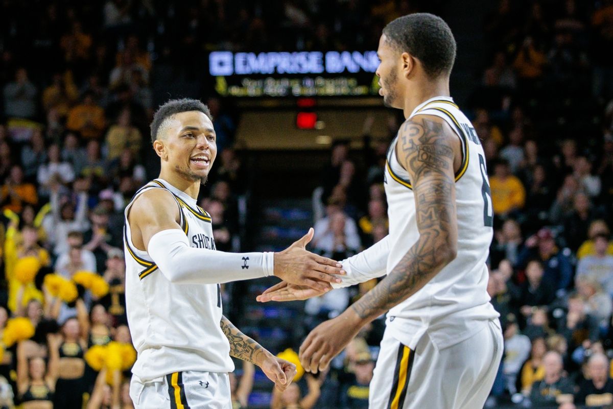 Feb 23, 2025; Wichita, Kansas, USA; Wichita State Shockers guard Xavier Bell (1) slaps hands with Wichita State Shockers forward Corey Washington (6) after a play during the second half against the Tulane Green Wave at Charles Koch Arena. Mandatory Credit: William Purnell-Imagn Images