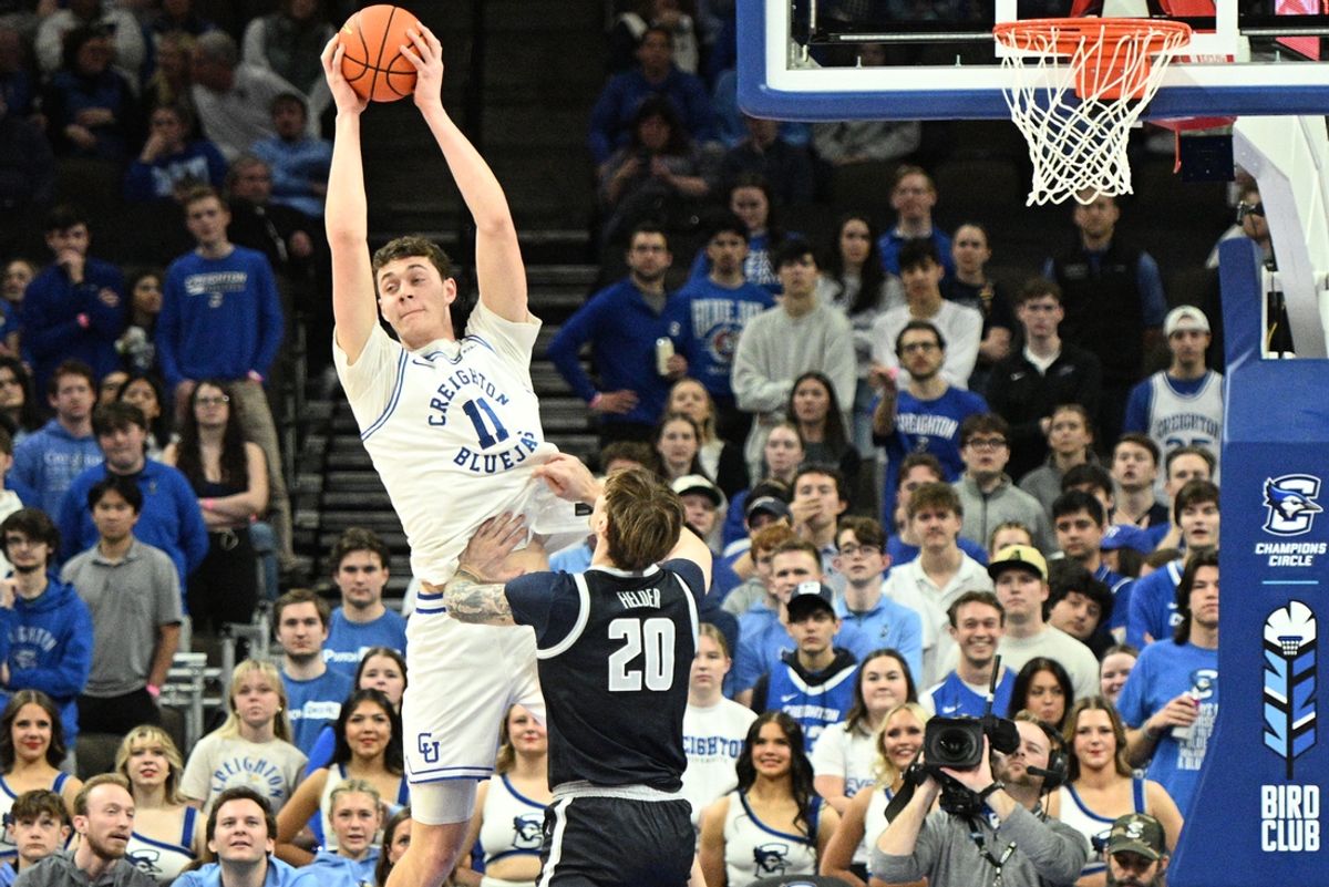 Feb 23, 2025; Omaha, Nebraska, USA;  Creighton Bluejays center Ryan Kalkbrenner (11) grabs a pass against Georgetown Hoyas forward Drew Fielder (20) during the first half at CHI Health Center Omaha. Mandatory Credit: Steven Branscombe-Imagn Images
