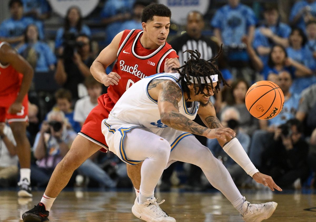 Feb 23, 2025; Los Angeles, California, USA; UCLA Bruins guard Skyy Clark (55) and Ohio State Buckeyes guard John Mobley Jr. (0) chase down a loose ball during the first half at Pauley Pavilion presented by Wescom. Mandatory Credit: Robert Hanashiro-Imagn Images