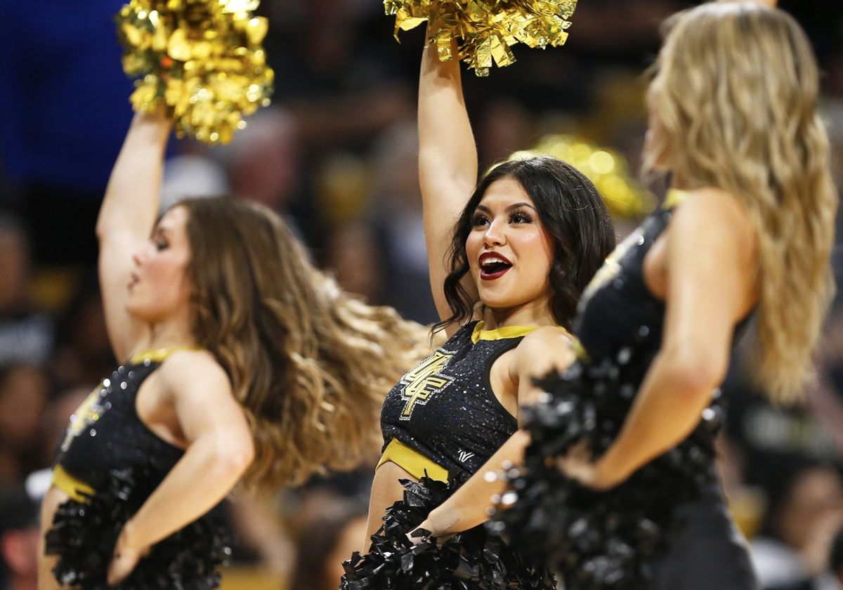 Feb 23, 2025; Orlando, Florida, USA; A UCF cheerleader performs during a break in action during the first half against the Utah Utes at Addition Financial Arena. Mandatory Credit: Russell Lansford-Imagn Images