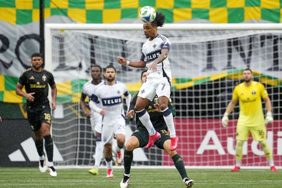 Feb 23, 2025; Portland, Oregon, USA; Vancouver Whitecaps FC midfielder Jayden Nelson (7) heads the ball during the first half against the Portland Timbers  at Providence Park. Mandatory Credit: Soobum Im-Imagn Images