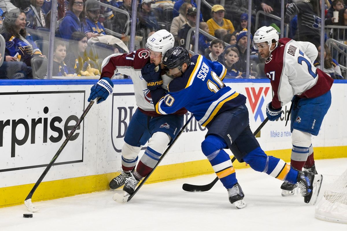 Feb 23, 2025; St. Louis, Missouri, USA;  Colorado Avalanche center Parker Kelly (17) and St. Louis Blues center Brayden Schenn (10)  battle for the puck during the first period at Enterprise Center. Mandatory Credit: Jeff Curry-Imagn Images