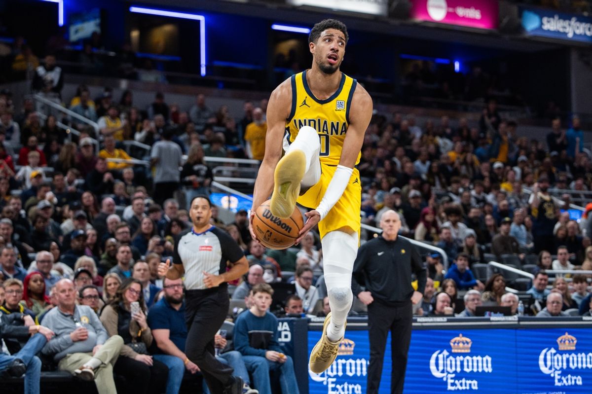 Feb 23, 2025; Indianapolis, Indiana, USA;  Indiana Pacers guard Tyrese Haliburton (0) passes the ball between his legs  in the second half against the LA Clippers at Gainbridge Fieldhouse. Mandatory Credit: Trevor Ruszkowski-Imagn Images