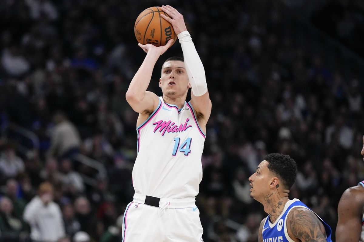 Feb 23, 2025; Milwaukee, Wisconsin, USA;  Miami Heat guard Tyler Herro (14) shoots during the fourth quarter against the Milwaukee Bucks at Fiserv Forum. Mandatory Credit: Jeff Hanisch-Imagn Images