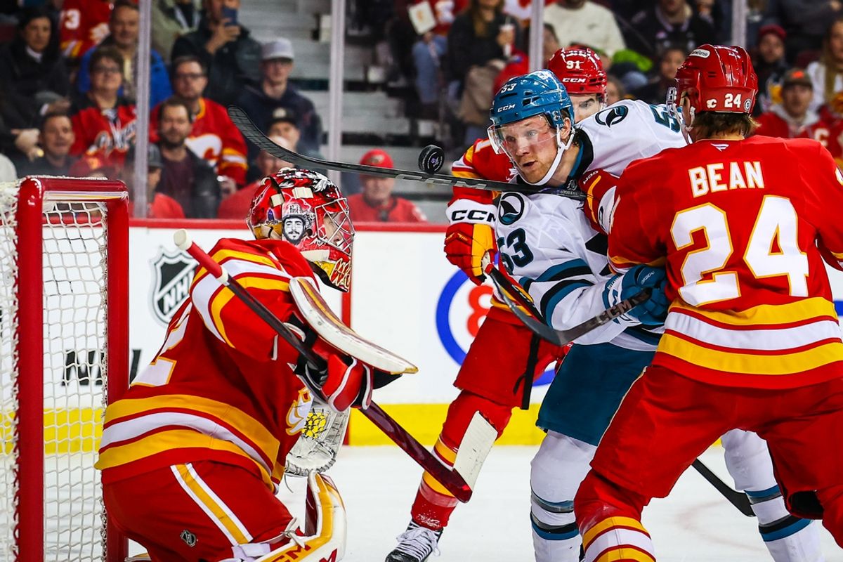 Feb 23, 2025; Calgary, Alberta, CAN; Calgary Flames goaltender Dustin Wolf (32) makes a save against San Jose Sharks center Ty Dellandrea (53) during the first period at Scotiabank Saddledome. Mandatory Credit: Sergei Belski-Imagn Images