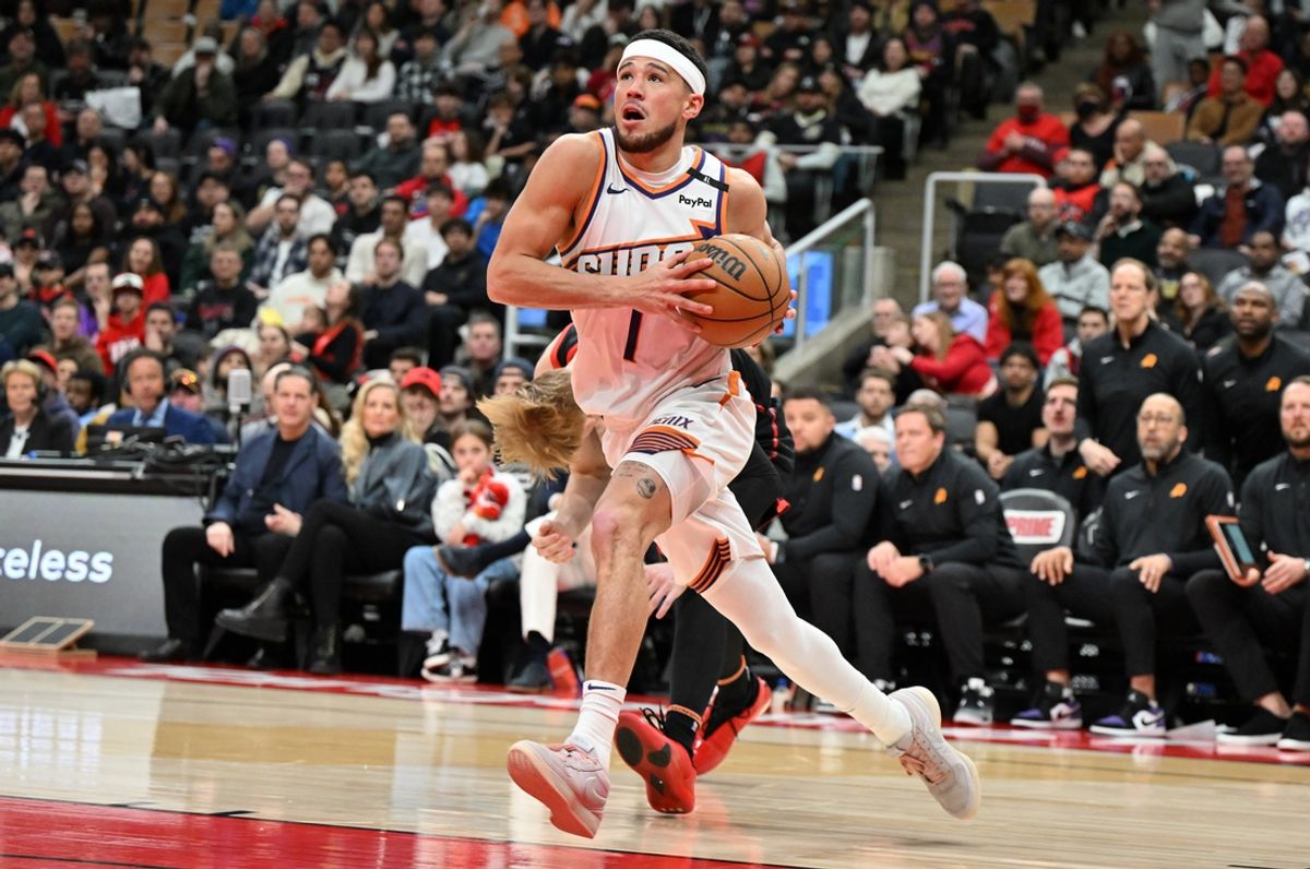 Feb 23, 2025; Toronto, Ontario, CAN;  Phoenix Suns guard Devin Booker (1) drives to the basket against the Toronto Raptors in the second half at Scotiabank Arena. Mandatory Credit: Dan Hamilton-Imagn Images