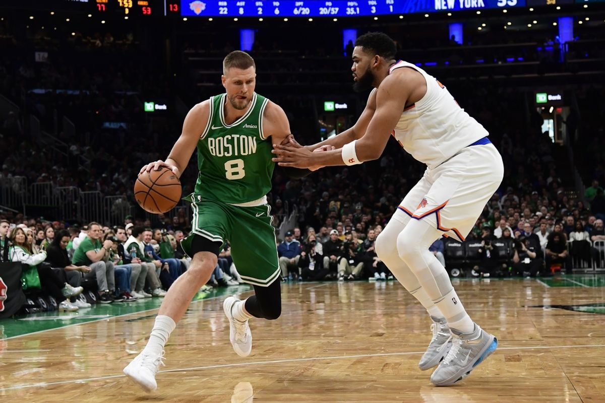 Feb 23, 2025; Boston, Massachusetts, USA;  Boston Celtics center Kristaps Porzingis (8) controls the ball while New York Knicks center Karl-Anthony Towns (32) defends during the second half at TD Garden. Mandatory Credit: Bob DeChiara-Imagn Images