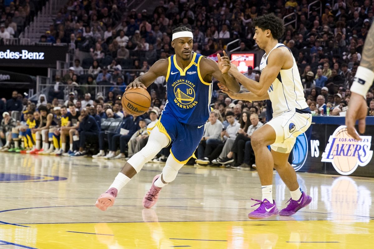 Feb 23, 2025; San Francisco, California, USA; Golden State Warriors forward Jimmy Butler III (10) drives past Dallas Mavericks guard Max Christie (00) during the third quarter at Chase Center. Mandatory Credit: John Hefti-Imagn Images