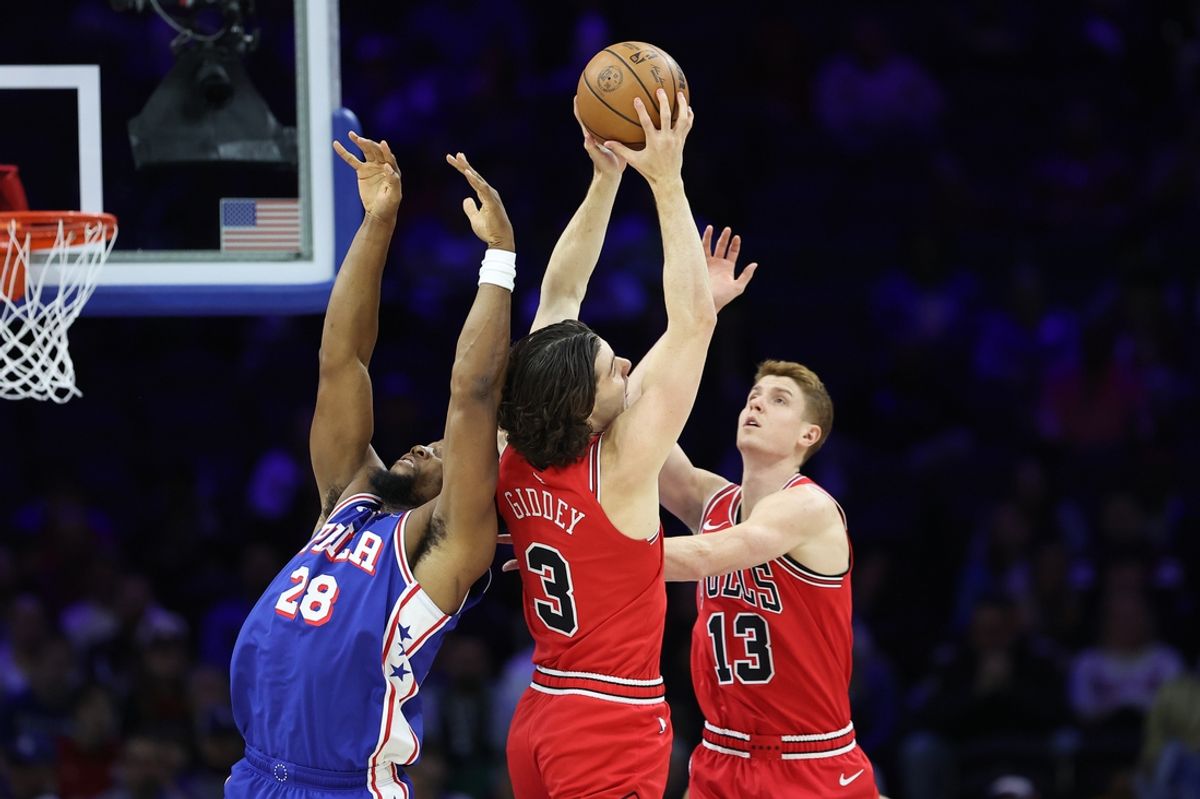 Feb 24, 2025; Philadelphia, Pennsylvania, USA; Chicago Bulls guard Josh Giddey (3) rebounds the ball past Philadelphia 76ers forward Guerschon Yabusele (28) during the first quarter at Wells Fargo Center. Mandatory Credit: Bill Streicher-Imagn Images