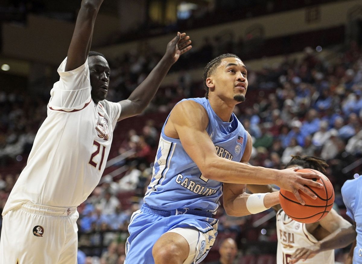 Feb 24, 2025; Tallahassee, Florida, USA; North Carolina Tarheels guard Seth Trimble (7) shoots the ball around Florida State Seminoles forward Alier Maluk (21) during the first half at Donald L. Tucker Center. Mandatory Credit: Melina Myers-Imagn Images
