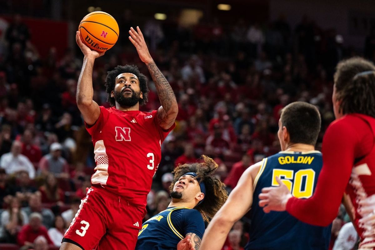 Feb 24, 2025; Lincoln, Nebraska, USA; Nebraska Cornhuskers guard Brice Williams (3) shoots the ball against Michigan Wolverines guard Tre Donaldson (3) and center Vladislav Goldin (50) during the first half at Pinnacle Bank Arena. Mandatory Credit: Dylan Widger-Imagn Images