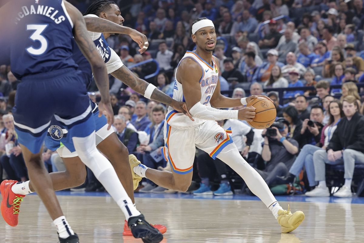 Feb 24, 2025; Oklahoma City, Oklahoma, USA; Oklahoma City Thunder guard Shai Gilgeous-Alexander (2) drives around Minnesota Timberwolves center Naz Reid (11) during the first quarter at Paycom Center. Mandatory Credit: Alonzo Adams-Imagn Images
