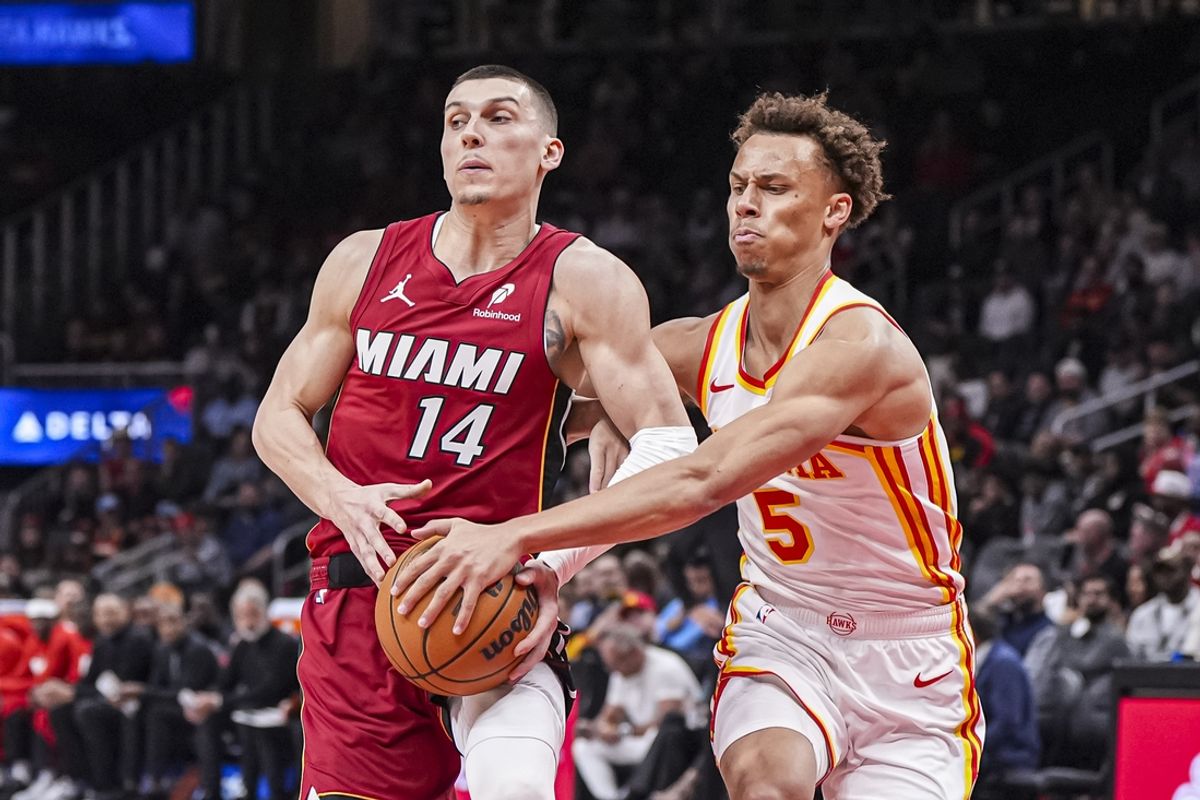 Feb 24, 2025; Atlanta, Georgia, USA; Miami Heat guard Tyler Herro (14) tries to protect the ball against Atlanta Hawks guard Dyson Daniels (5) during the first half at State Farm Arena. Mandatory Credit: Dale Zanine-Imagn Images