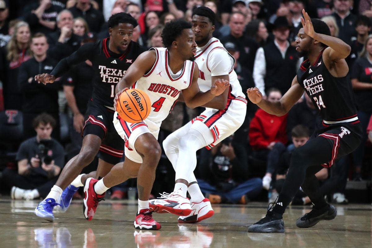 Feb 24, 2025; Lubbock, Texas, USA;  Houston Cougars guard LJ Cryer (4) dribbles the ball against Texas Tech Red Raiders guard Kerwin Walton (24) in the first half at United Supermarkets Arena. Mandatory Credit: Michael C. Johnson-Imagn Images