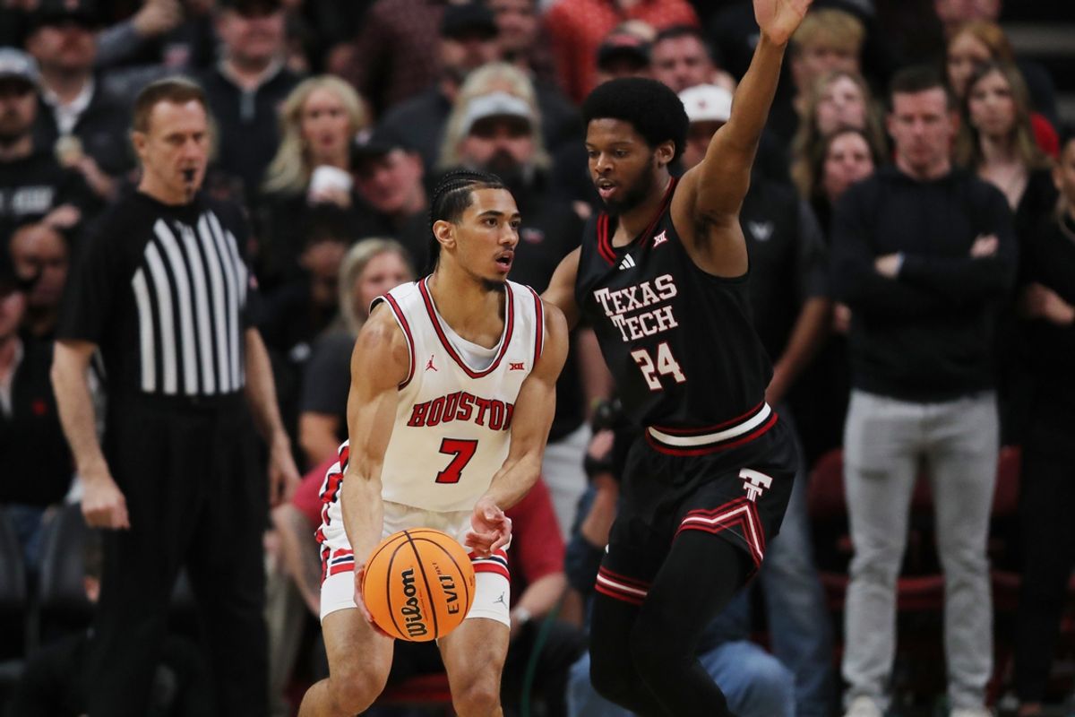Feb 24, 2025; Lubbock, Texas, USA;  Houston Cougars guard Milos Uzan (7) passes the ball against Texas Tech Red Raiders guard Kerwin Walton (24) in the first half at United Supermarkets Arena. Mandatory Credit: Michael C. Johnson-Imagn Images