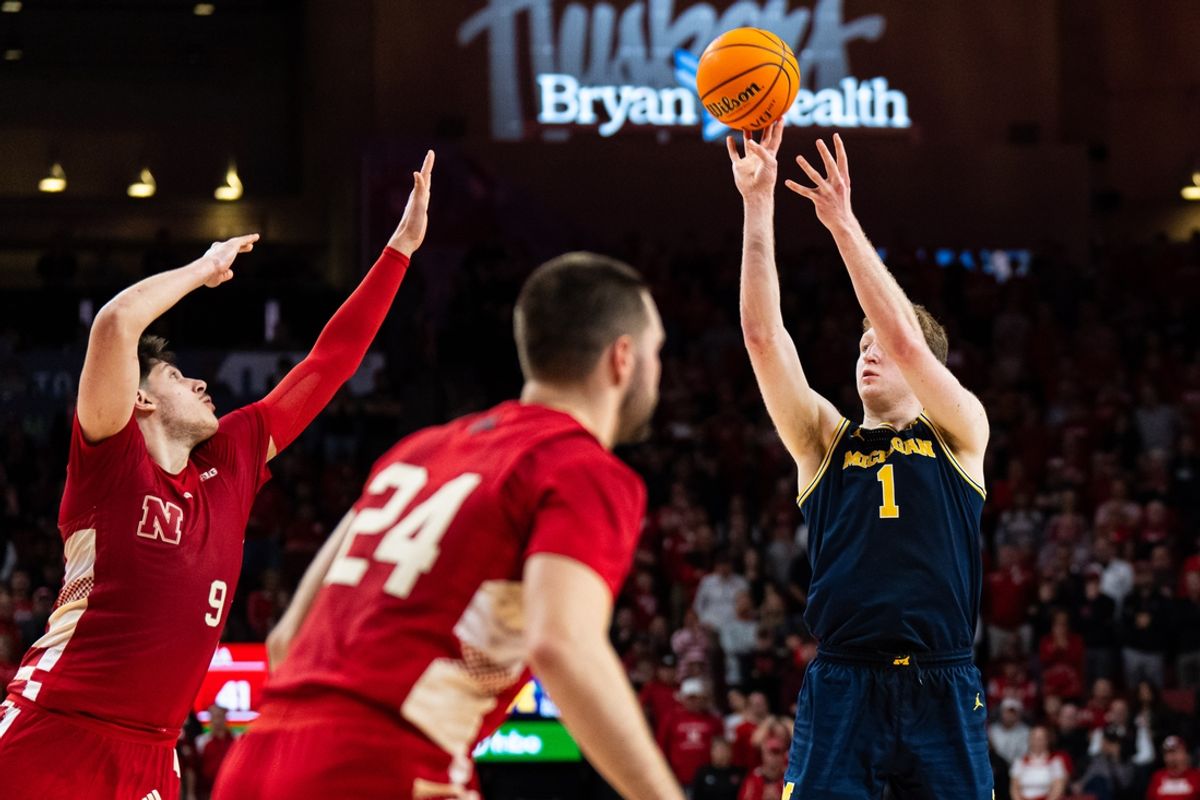 Feb 24, 2025; Lincoln, Nebraska, USA; Michigan Wolverines center Danny Wolf (1) shoots the ball against Nebraska Cornhuskers forward Berke Buyuktuncel (9) and guard Rollie Worster (24) during the second half at Pinnacle Bank Arena. Mandatory Credit: Dylan Widger-Imagn Images