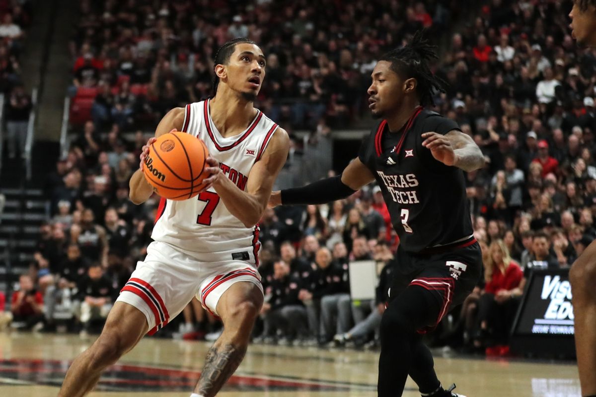 Feb 24, 2025; Lubbock, Texas, USA;  Houston Cougars guard Milos Uzan (7) looks to shoot against Texas Tech Red Raiders guard Elijah Hawkins (3) in the second half  at United Supermarkets Arena. Mandatory Credit: Michael C. Johnson-Imagn Images