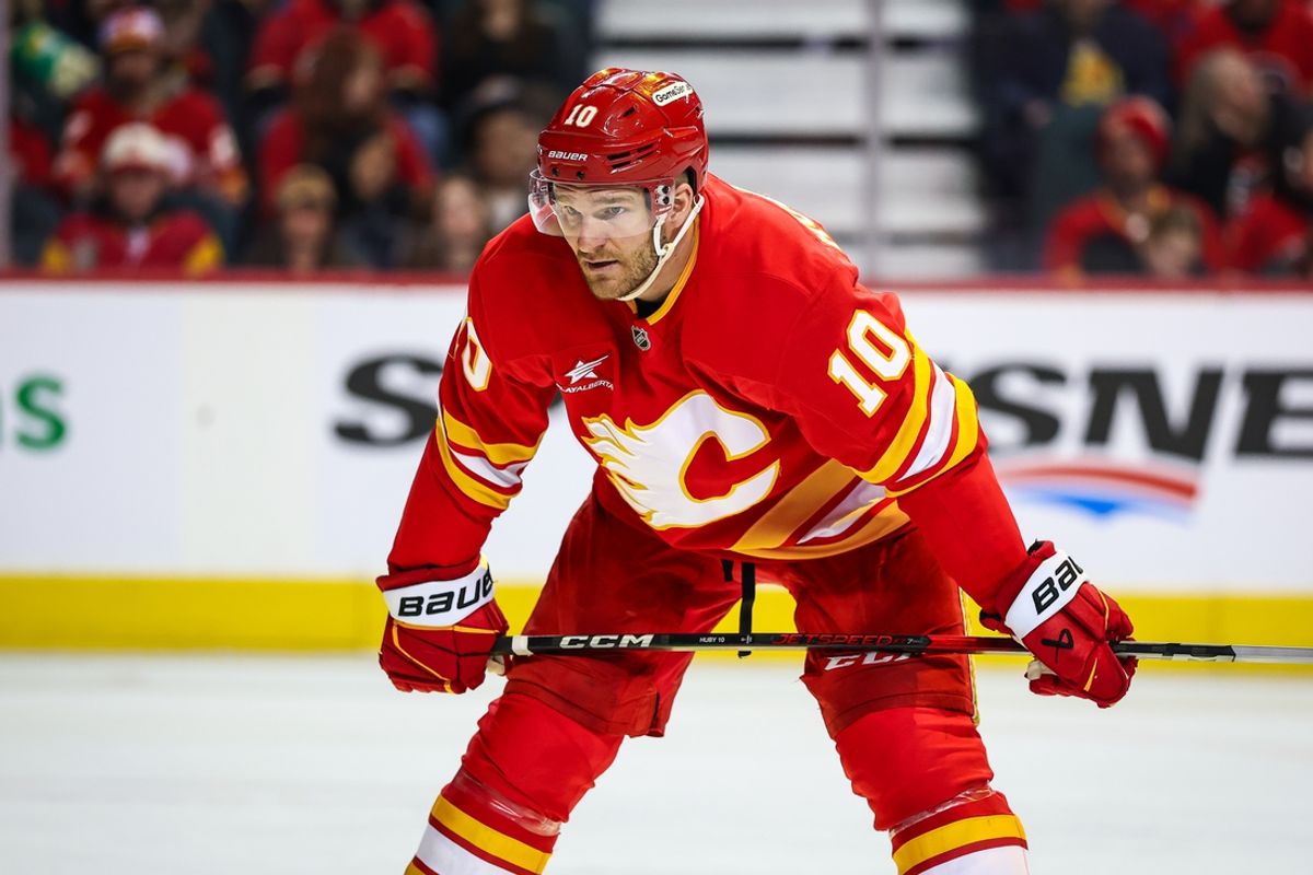 Feb 23, 2025; Calgary, Alberta, CAN; Calgary Flames left wing Jonathan Huberdeau (10) during the face off against the San Jose Sharks during the second period at Scotiabank Saddledome. Mandatory Credit: Sergei Belski-Imagn Images
