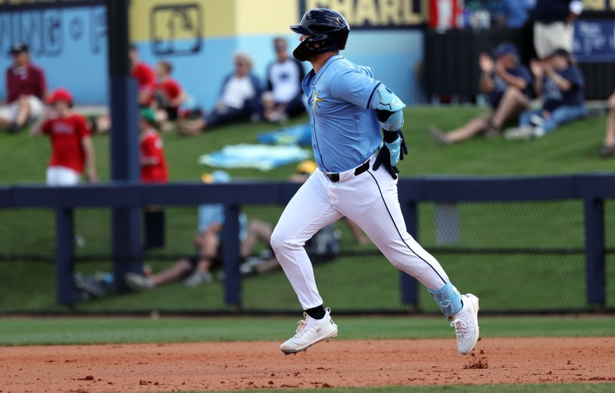 Feb 25, 2025; Port Charlotte, Florida, USA;  Tampa Bay Rays second base Curtis Mead (25) hits a RBI double against the Philadelphia Phillies during the fourth inning at Charlotte Sports Park. Mandatory Credit: Kim Klement Neitzel-Imagn Images