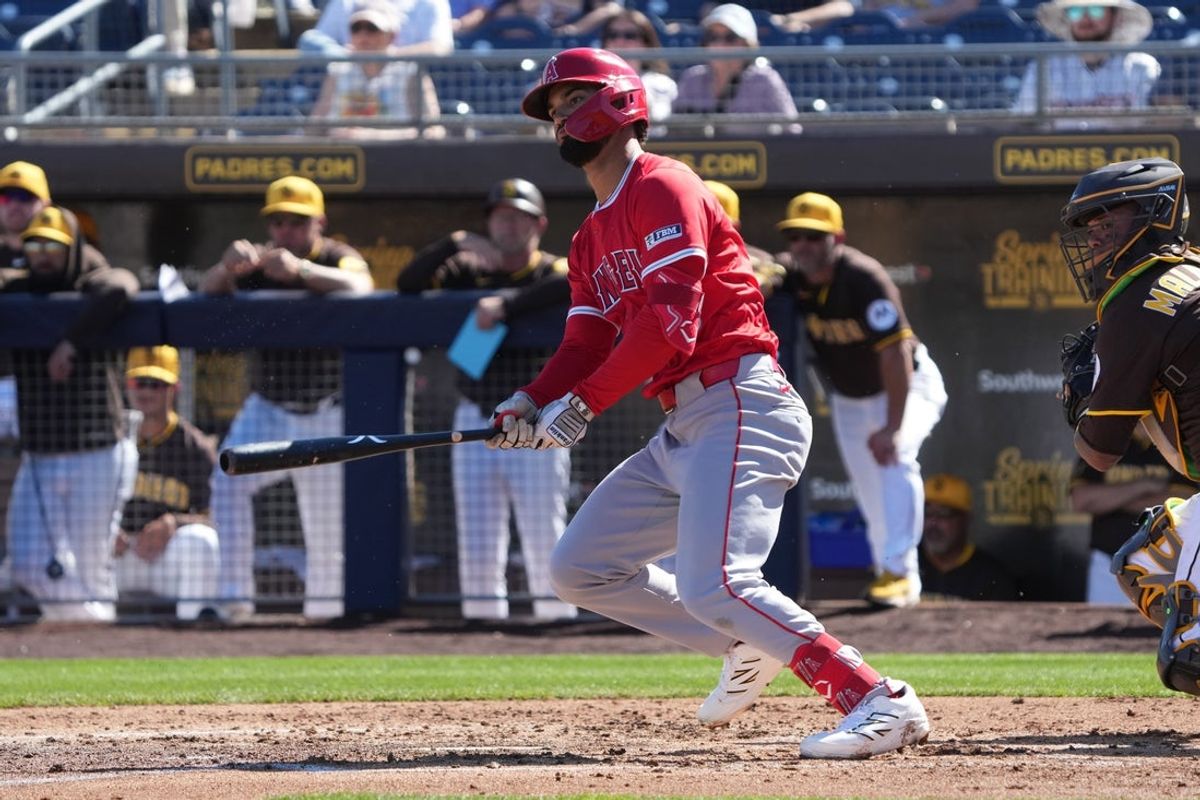 Feb 25, 2025; Peoria, Arizona, USA; Los Angeles Angels outfielder Matthew Lugo (15) hits a single against the San Diego Padres during the third inning at Peoria Sports Complex. Mandatory Credit: Rick Scuteri-Imagn Images