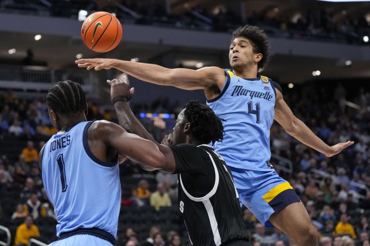 Feb 25, 2025; Milwaukee, Wisconsin, USA;  Marquette Golden Eagles guard Stevie Mitchell (4) reaches for the ball during the first half against the Providence Friars at Fiserv Forum. Mandatory Credit: Jeff Hanisch-Imagn Images