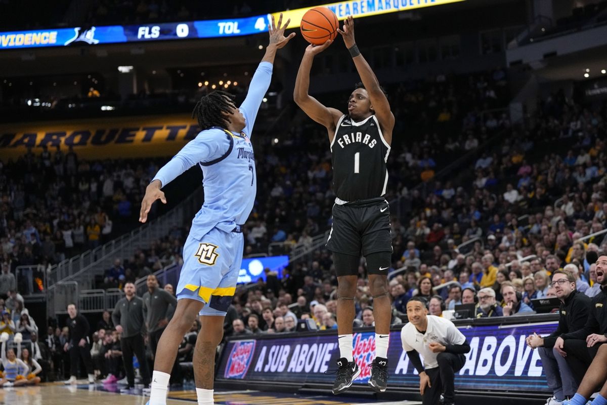 Feb 25, 2025; Milwaukee, Wisconsin, USA;  Marquette Golden Eagles guard Kam Jones (1) shoots against Marquette Golden Eagles guard Zaide Lowery (7) during the first half at Fiserv Forum. Mandatory Credit: Jeff Hanisch-Imagn Images