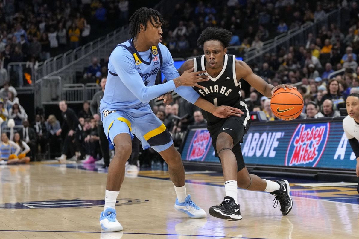Feb 25, 2025; Milwaukee, Wisconsin, USA;  Providence Friars guard Jayden Pierre (1) drives for the basket against  Marquette Golden Eagles guard Zaide Lowery (7) during the first half at Fiserv Forum. Mandatory Credit: Jeff Hanisch-Imagn Images