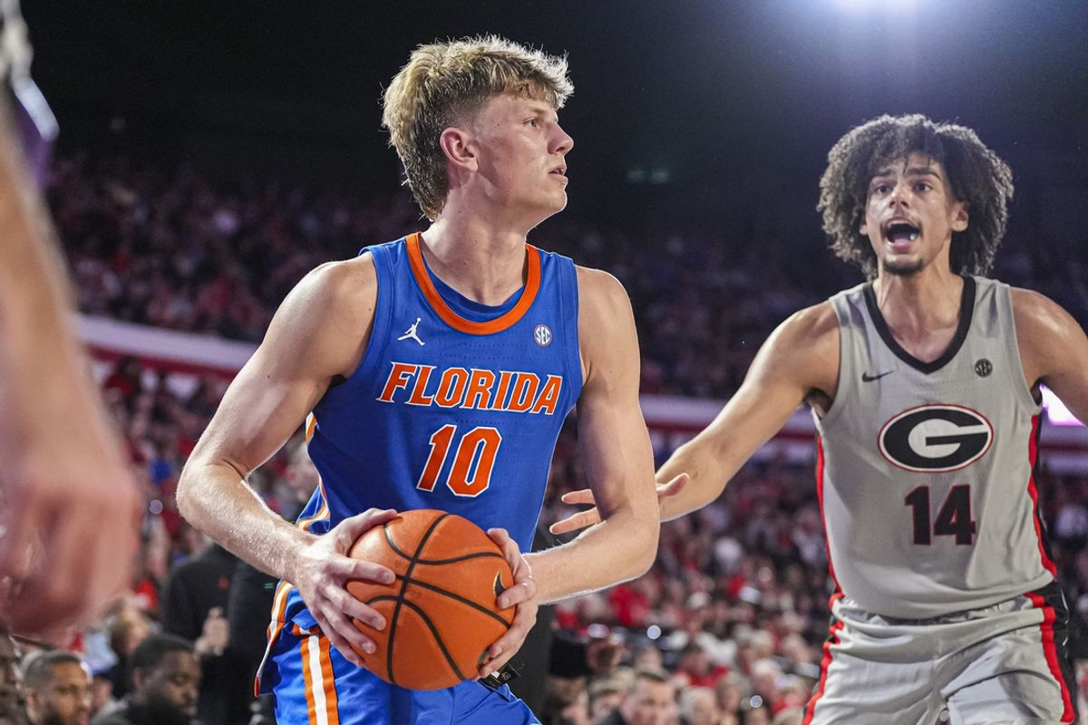 Feb 25, 2025; Athens, Georgia, USA; Florida Gators forward Thomas Haugh (10) handles the ball against Georgia Bulldogs forward Asa Newell (14) during the first half at Stegeman Coliseum. Mandatory Credit: Dale Zanine-Imagn Images