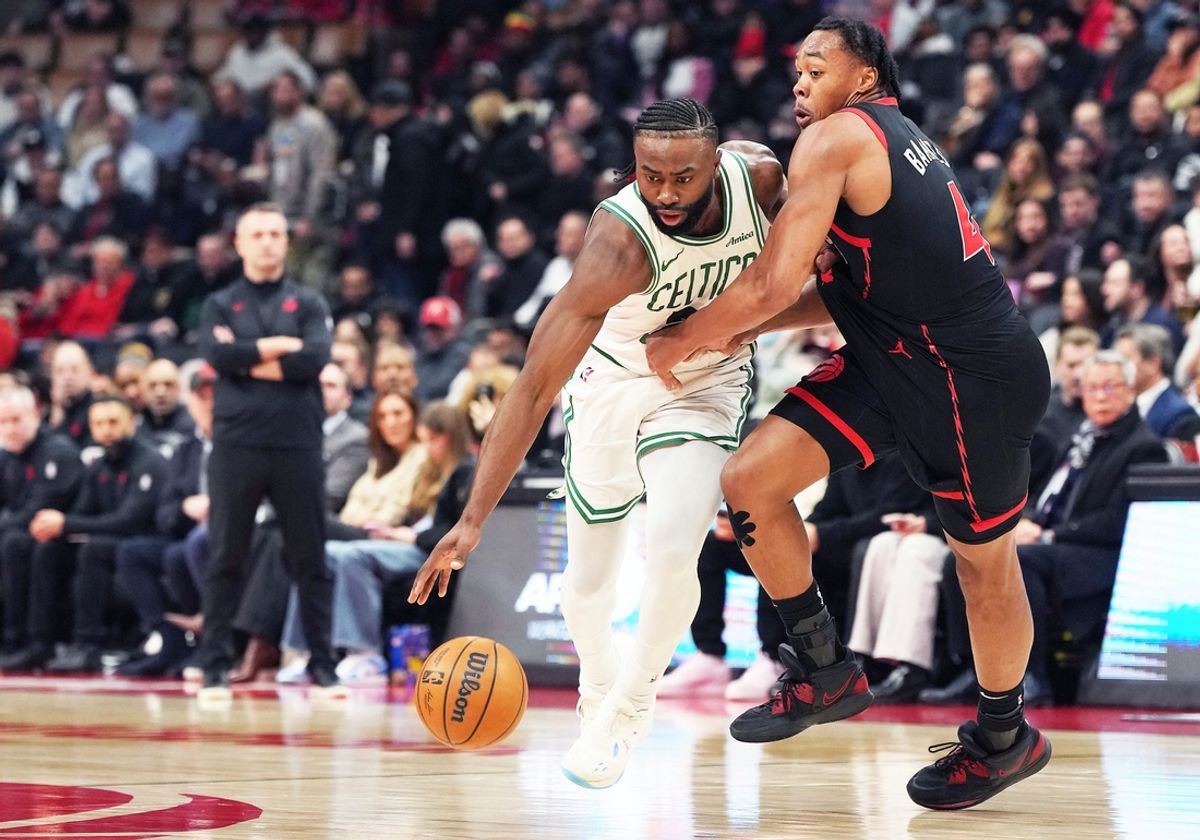Feb 25, 2025; Toronto, Ontario, CAN; Boston Celtics guard Jaylen Brown (7) controls the ball as Toronto Raptors forward Scottie Barnes (4) tries to defend during the second quarter at the Scotiabank Arena. Mandatory Credit: Nick Turchiaro-Imagn Images