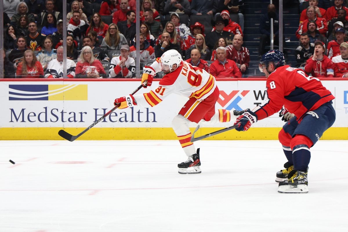 Feb 25, 2025; Washington, District of Columbia, USA; Calgary Flames center Nazem Kadri (91) /sto/ as Washington Capitals left wing Alex Ovechkin (8) chases in the second period at Capital One Arena. Mandatory Credit: Geoff Burke-Imagn Images