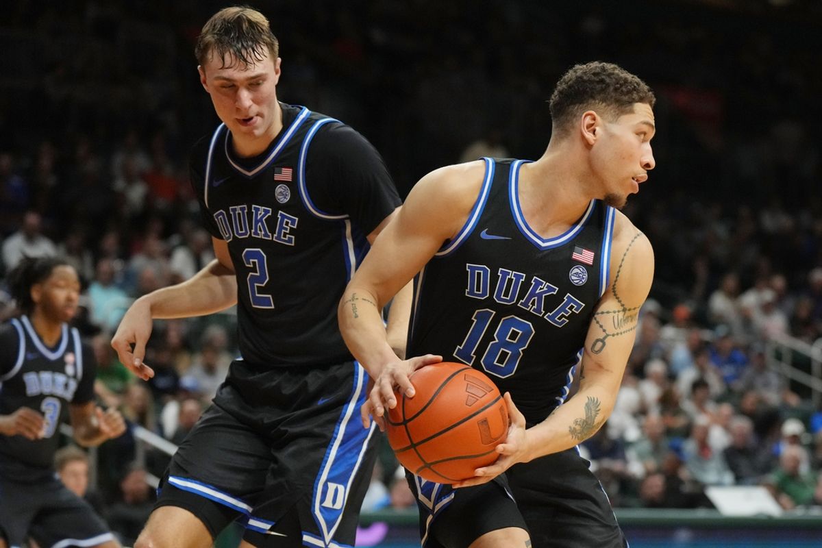 Feb 25, 2025; Coral Gables, Florida, USA;  Duke Blue Devils forward Mason Gillis (18) grabs a rebound as guard Cooper Flagg (2) follows on the play during the second half at Watsco Center. Mandatory Credit: Jim Rassol-Imagn Images