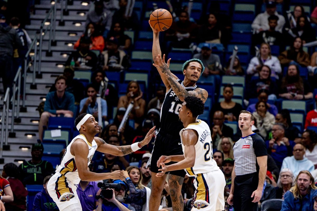 Feb 25, 2025; New Orleans, Louisiana, USA;  San Antonio Spurs forward Jeremy Sochan (10) passes against New Orleans Pelicans forward Bruce Brown (00) and guard Trey Murphy III (25) during the first half at Smoothie King Center. Mandatory Credit: Stephen Lew-Imagn Images