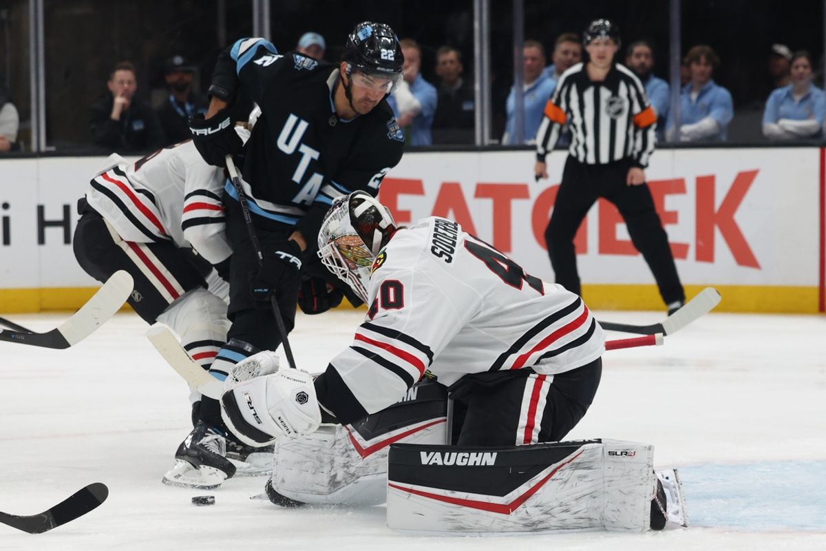 Feb 25, 2025; Salt Lake City, Utah, USA; Utah Hockey Club center Jack McBain (22) looks for a rebound from Chicago Blackhawks goaltender Arvid Soderblom (40) during the first period at Delta Center. Mandatory Credit: Rob Gray-Imagn Images