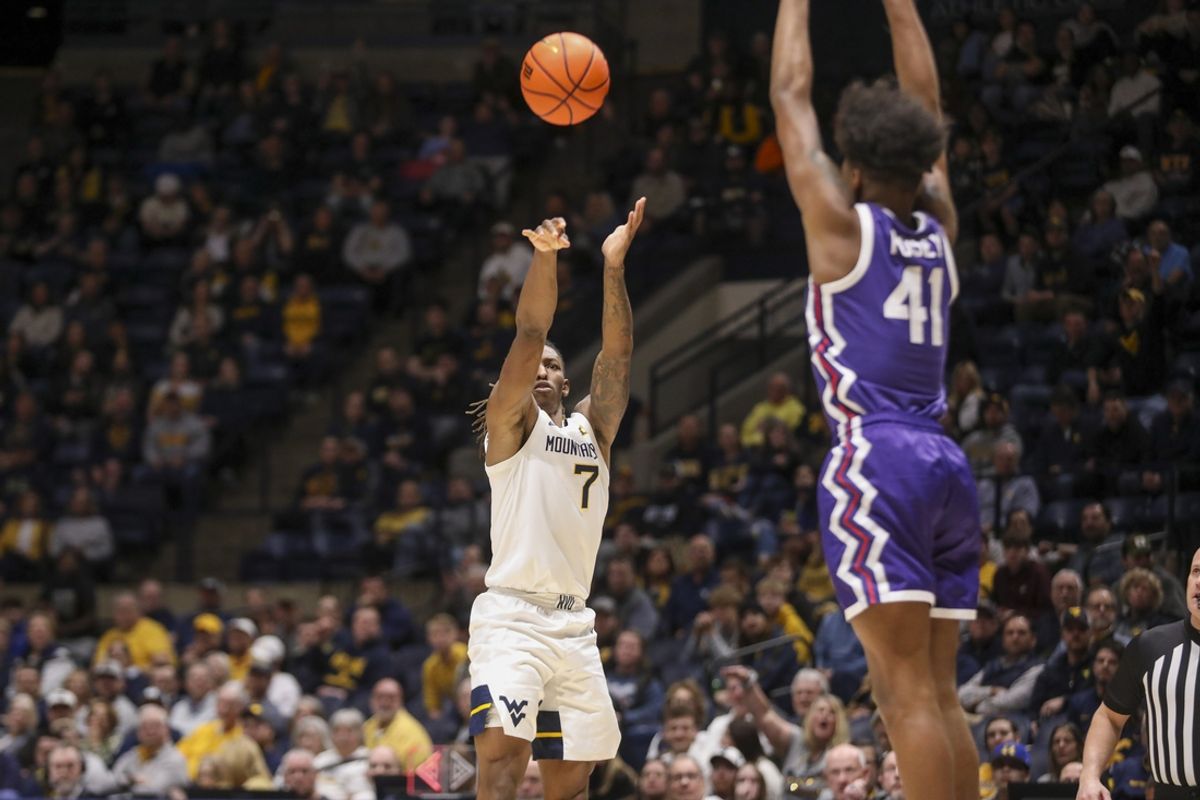 Feb 25, 2025; Morgantown, West Virginia, USA; West Virginia Mountaineers guard Javon Small (7) shoots over TCU Horned Frogs guard Jace Posey (41) during the first half at WVU Coliseum. Mandatory Credit: Ben Queen-Imagn Images