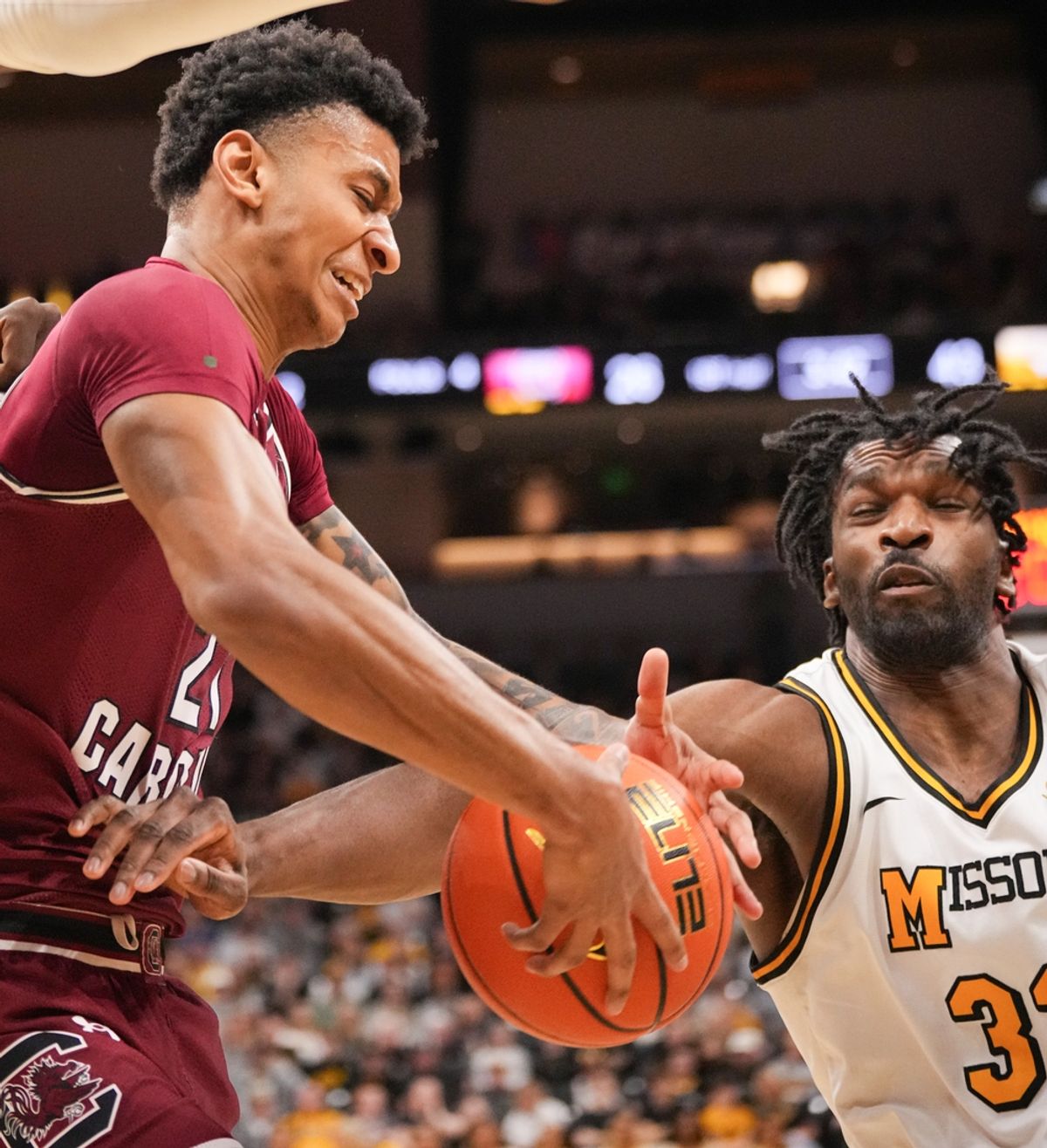 Feb 25, 2025; Columbia, Missouri, USA; South Carolina Gamecocks guard Arden Conyers (21) and Missouri Tigers center Josh Gray (33) fight for a rebound during the first half at Mizzou Arena. Mandatory Credit: Denny Medley-Imagn Images