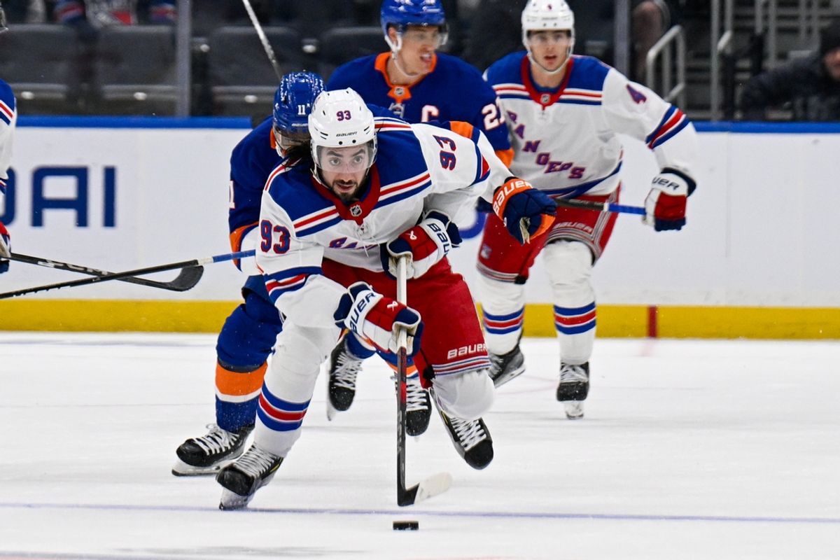 Feb 25, 2025; Elmont, New York, USA;  New York Rangers center Mika Zibanejad (93) skates the puck against the New York Islanders during the third period at UBS Arena. Mandatory Credit: Dennis Schneidler-Imagn Images