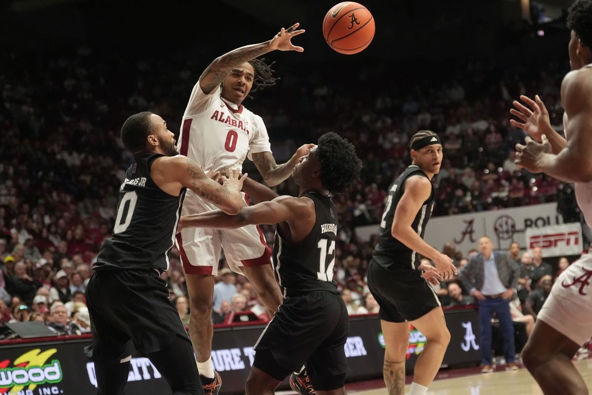 Feb 25, 2025; Tuscaloosa, AL, USA;  Alabama guard Labaron Philon (0) makes a pass over Mississippi State guard Claudell Harris (0) and Mississippi State guard Josh Hubbard (12) at Coleman Coliseum. Mandatory Credit: Gary Cosby Jr.-Tuscaloosa News