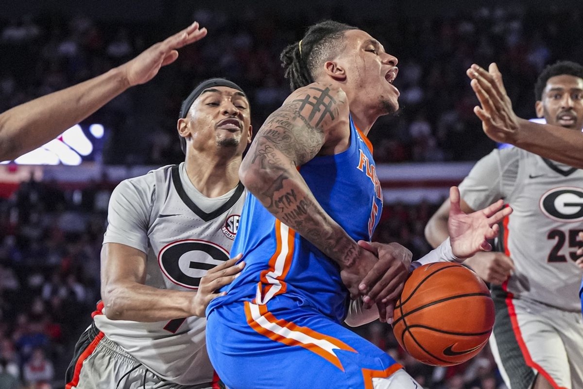 Feb 25, 2025; Athens, Georgia, USA; Florida Gators guard Will Richard (5) is stripped of the ball by Georgia Bulldogs guard Tyrin Lawrence (7) during the second half at Stegeman Coliseum. Mandatory Credit: Dale Zanine-Imagn Images