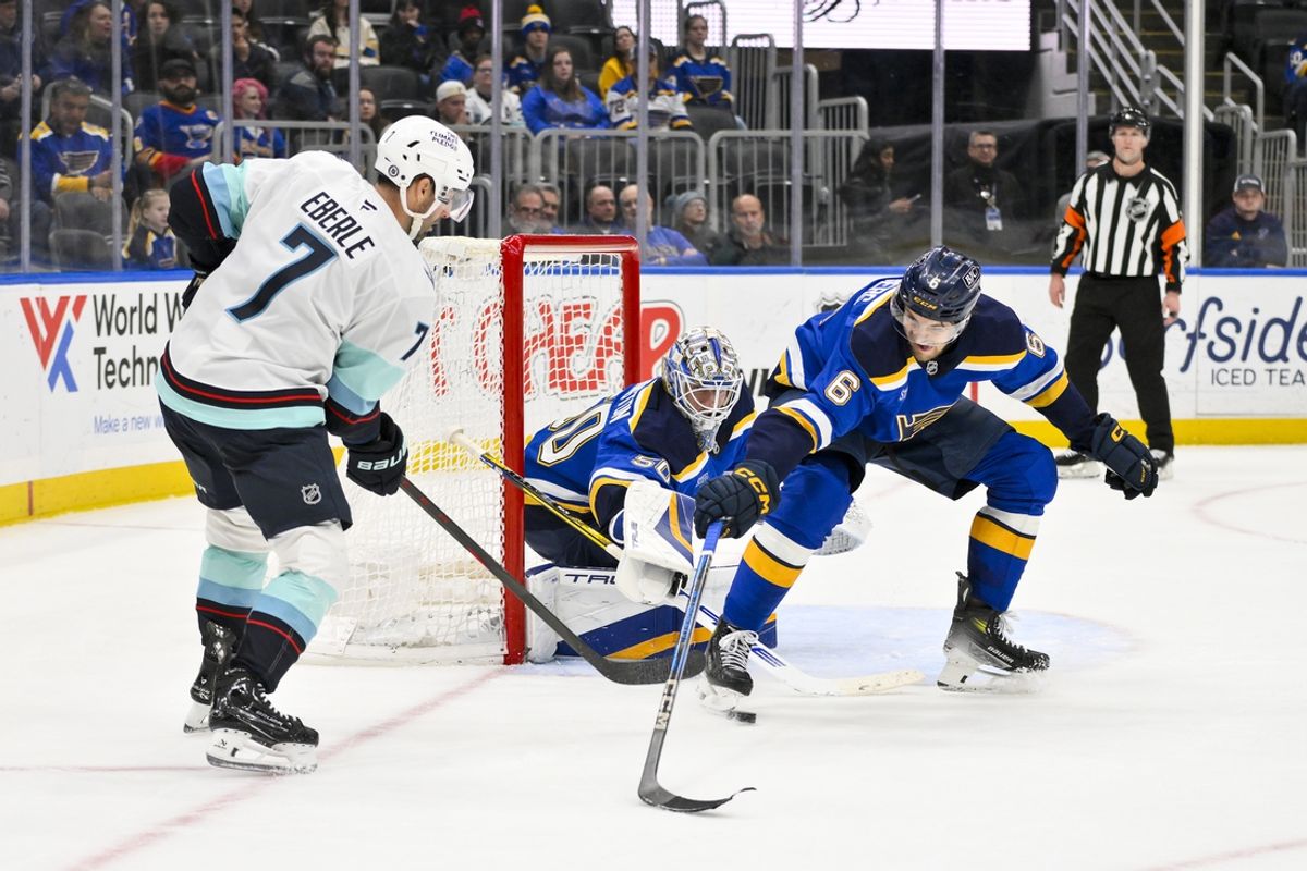 Feb 25, 2025; St. Louis, Missouri, USA;  St. Louis Blues goaltender Jordan Binnington (50) and defenseman Philip Broberg (6) defend the net against Seattle Kraken right wing Jordan Eberle (7) during the third period at Enterprise Center. Mandatory Credit: Jeff Curry-Imagn Images