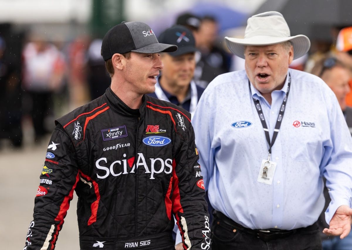 Feb 15, 2025; Daytona Beach, Florida, USA; NASCAR Xfinity Series driver Ryan Sieg (left) with HAAS Factory Team official Joe Custer during qualifying for the United Rentals 300 at Daytona International Speedway. Mandatory Credit: Mark J. Rebilas-Imagn Images